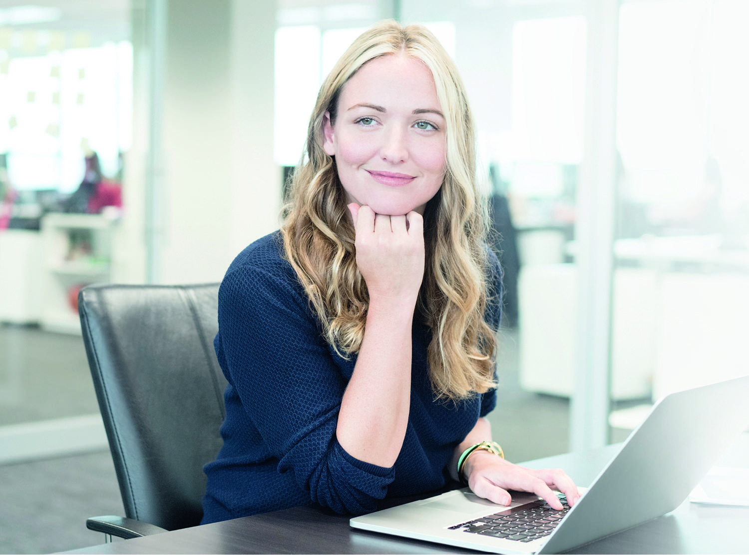 Female working on her computer in office building