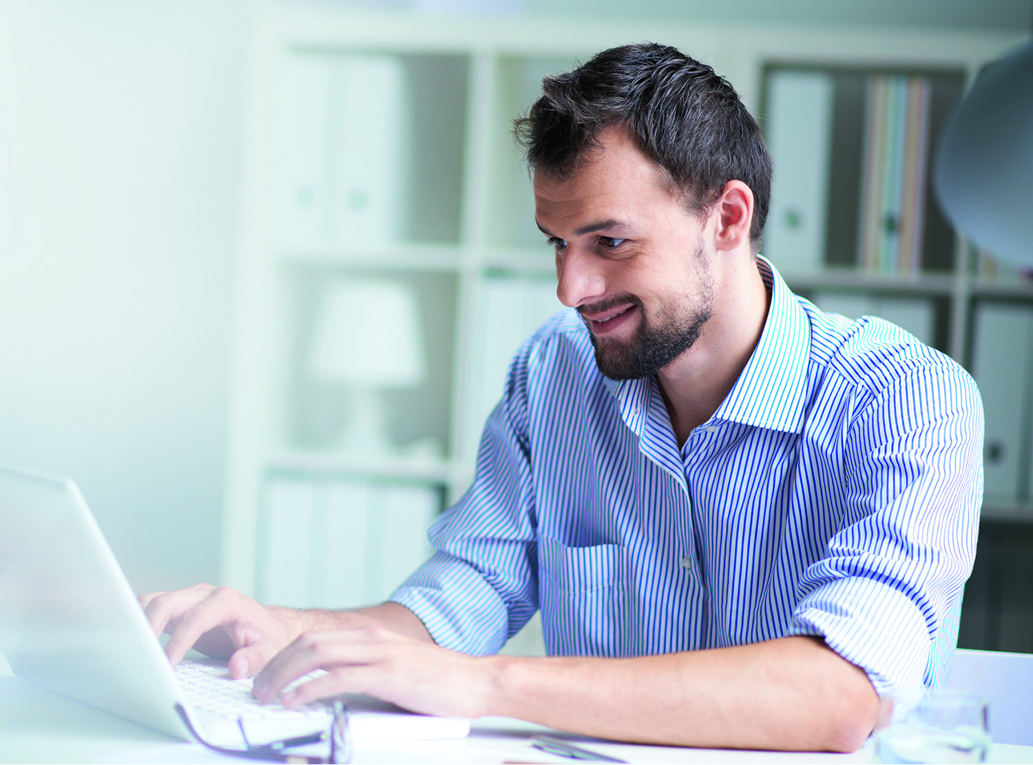Man working on a laptop in an office building