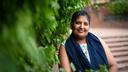 Simran Sethi stands against a wall at Dilli Haat market in Delhi, India, her favorite place to recharge power after her breast cancer diagnosis.