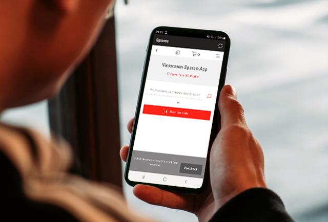 Man holding phone with Viessmann Spare Parts App 