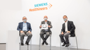 Scientists and physicians at Siemens Healthineers show their enthusiasm for Biograph Vision Quadra by holding up a smiling face