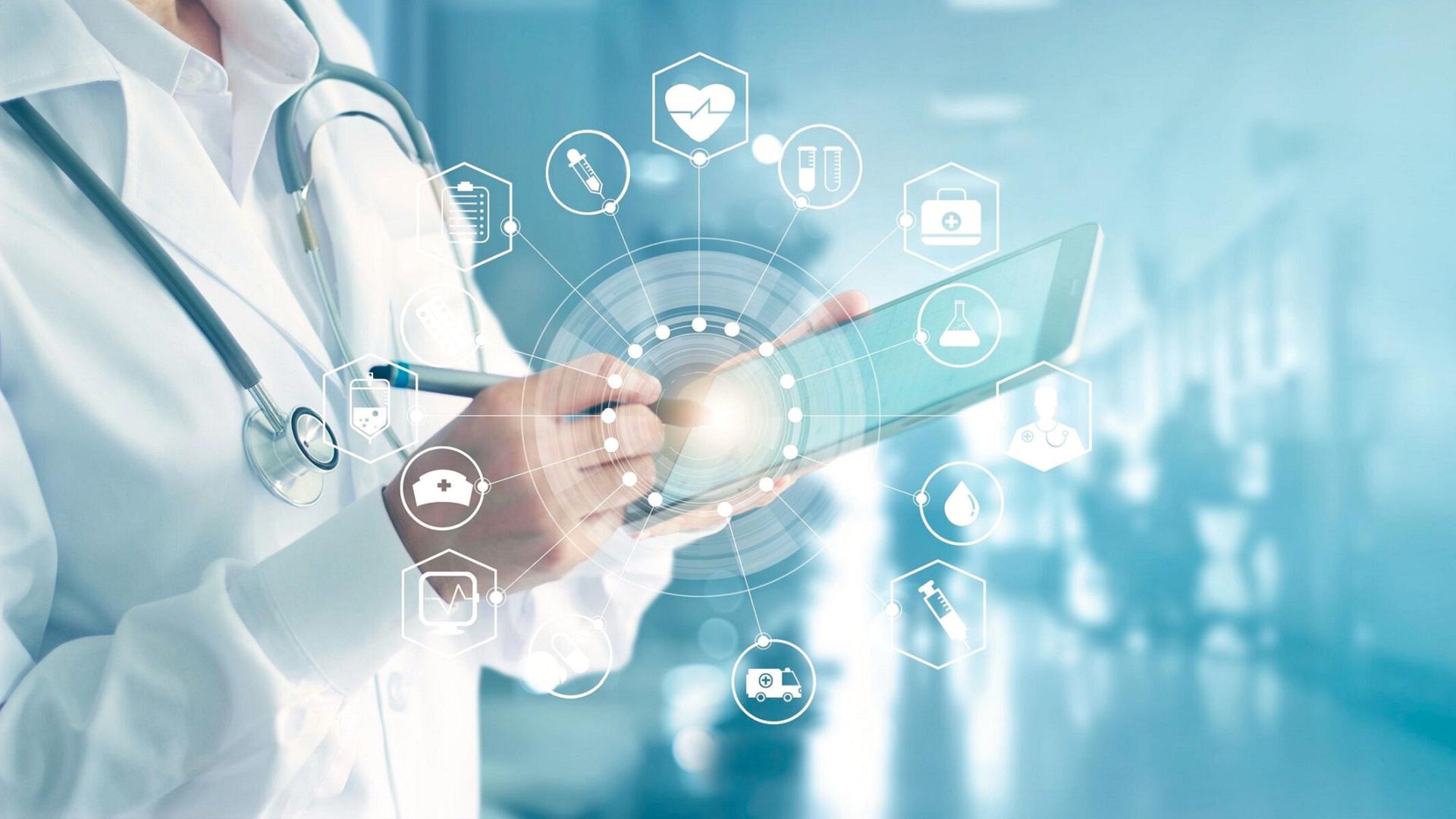 futuristic image of a doctor holding a tablet and different healthcare related app symbols visualized around the clinicians' hand