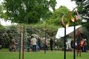 Menschen betrachten Kunstobjekte im Botanischen Garten