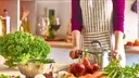 Young woman cooking healthy food in the kitchen