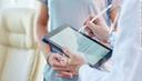 Male doctor with tablet during informative conversation with patient