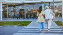 Grandmother and Granddaughter Walking Together to a Shopping Mall 