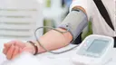 Arm of a patient with a blood pressure monitor