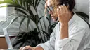 Young woman on the phone at work