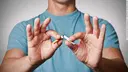 Young man breaking a cigarette
