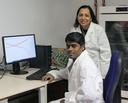 Two scientists in front of a PC