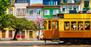 Historische Straßenbahn vor den bunten Häusern Portos in Portugal.