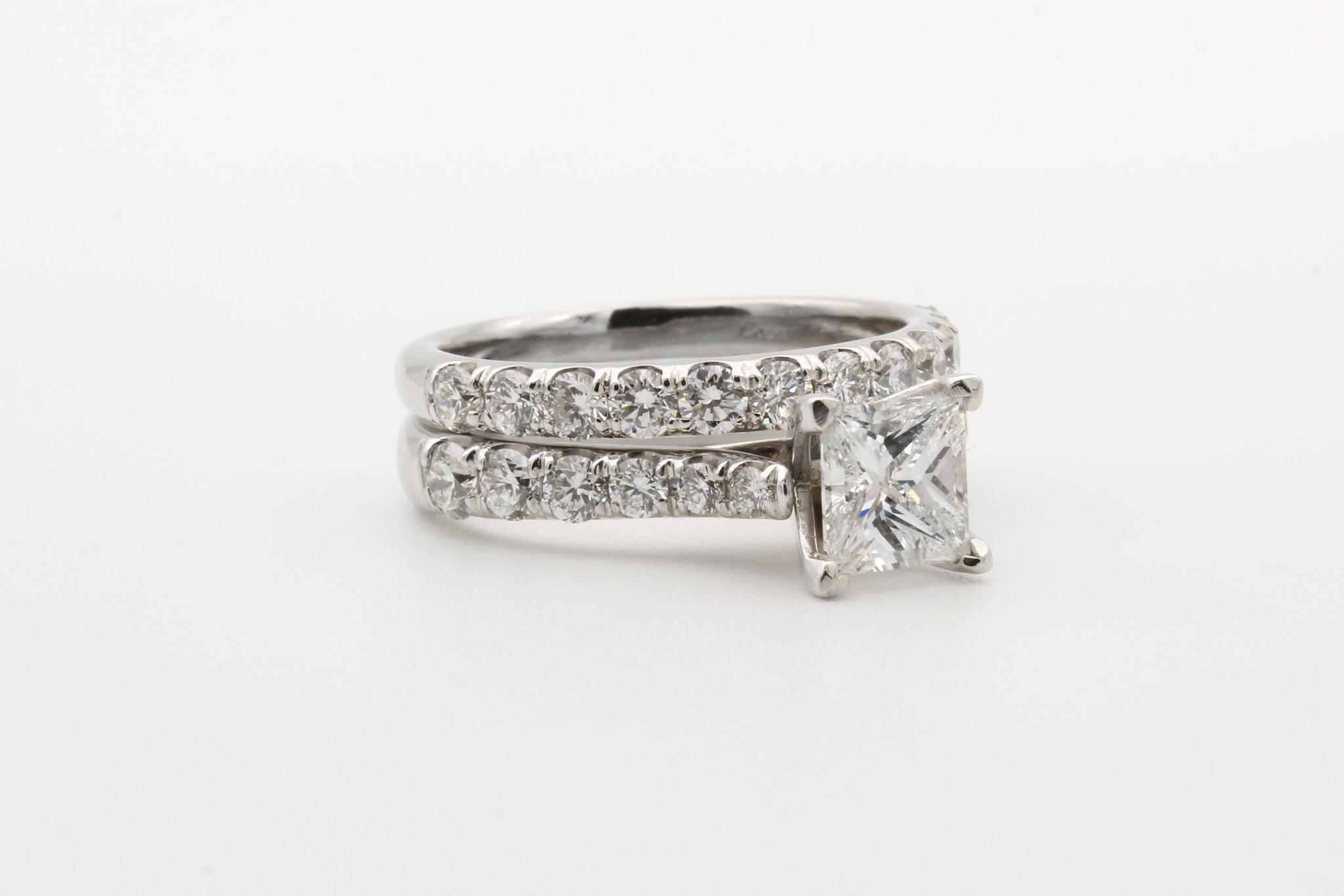 Two silver-colored rings set with clear gemstones.