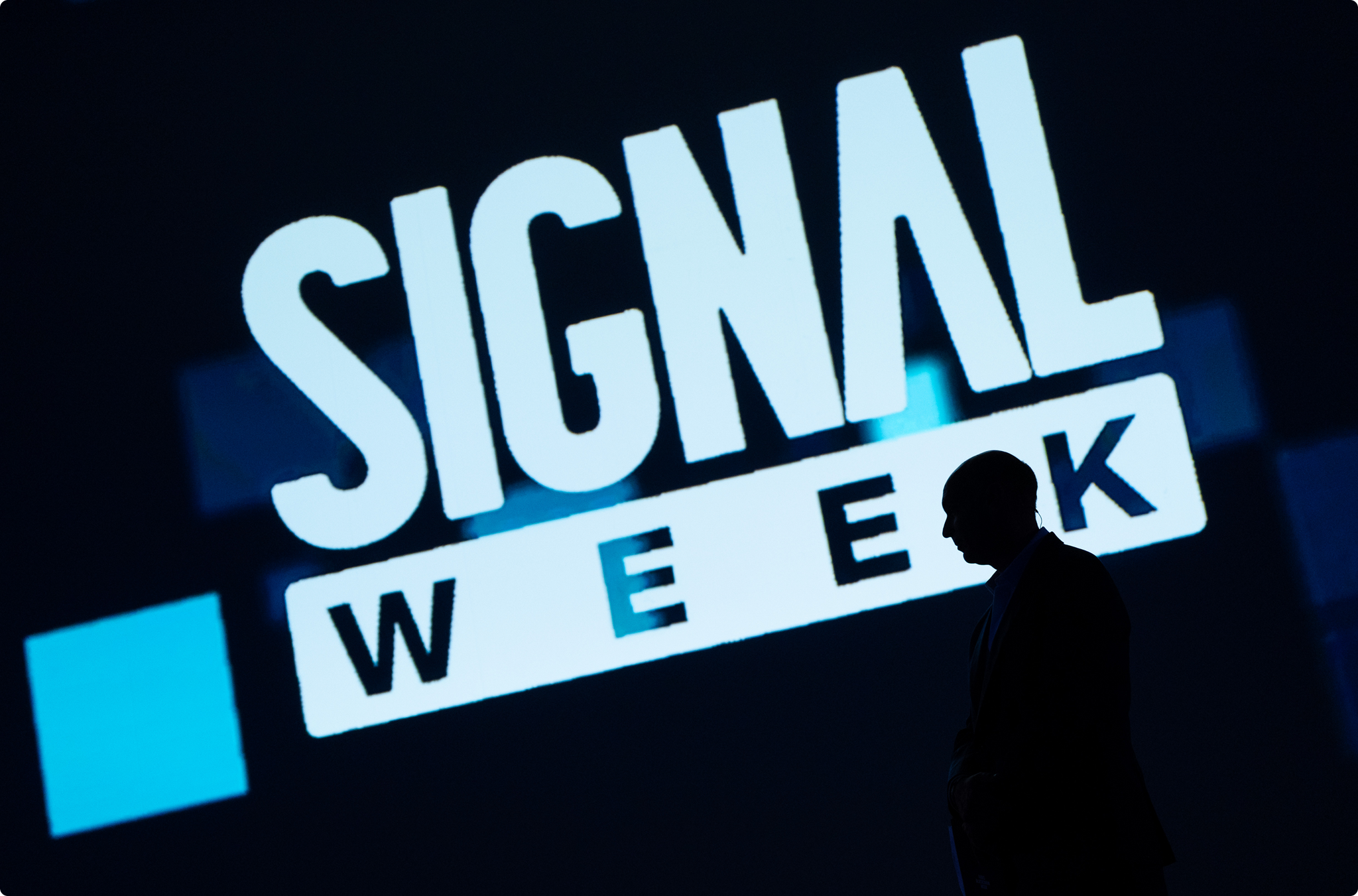 Signal Week branding displayed behind a silhouetted person in official website artwork.