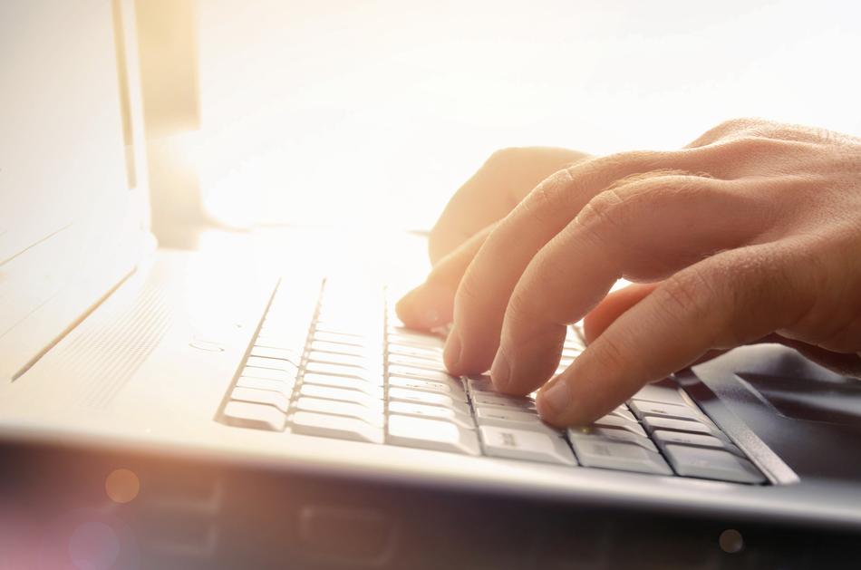 Finger tippen auf einem Laptop