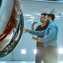 a mechanic and an engineer examine an aircraft engine