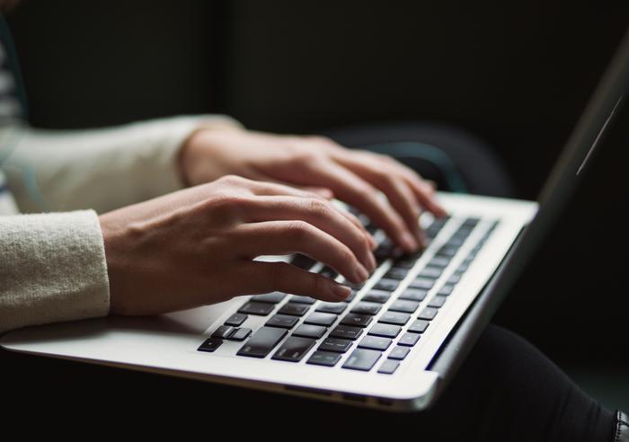 Typing on a laptop